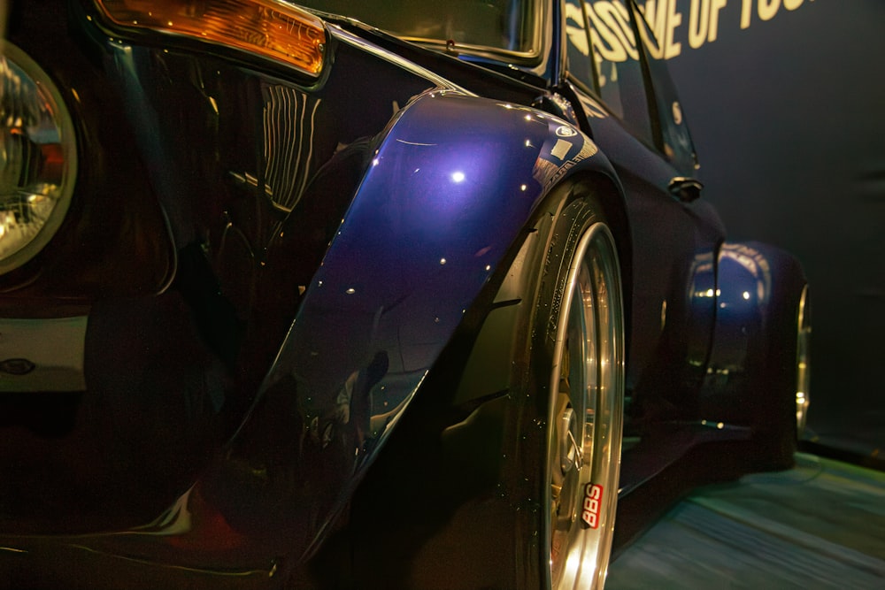 a close up of a car on display at a car show