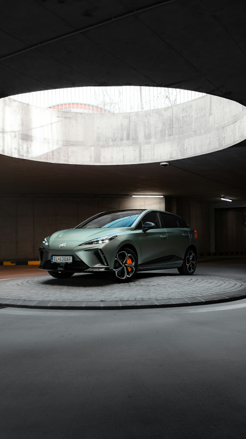 a green car parked in a parking garage