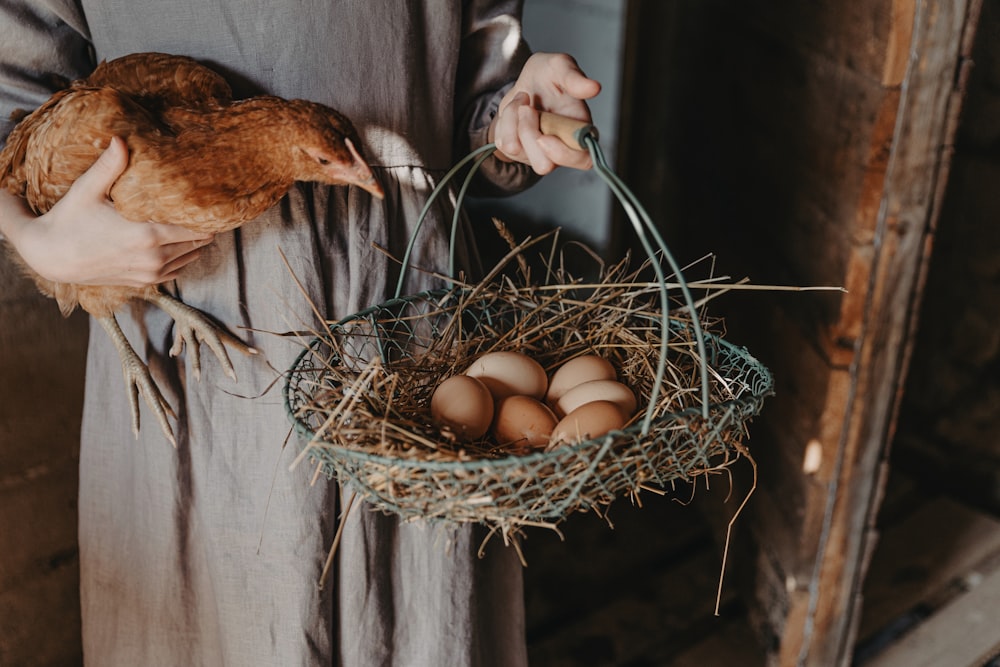 a person holding a basket with eggs in it