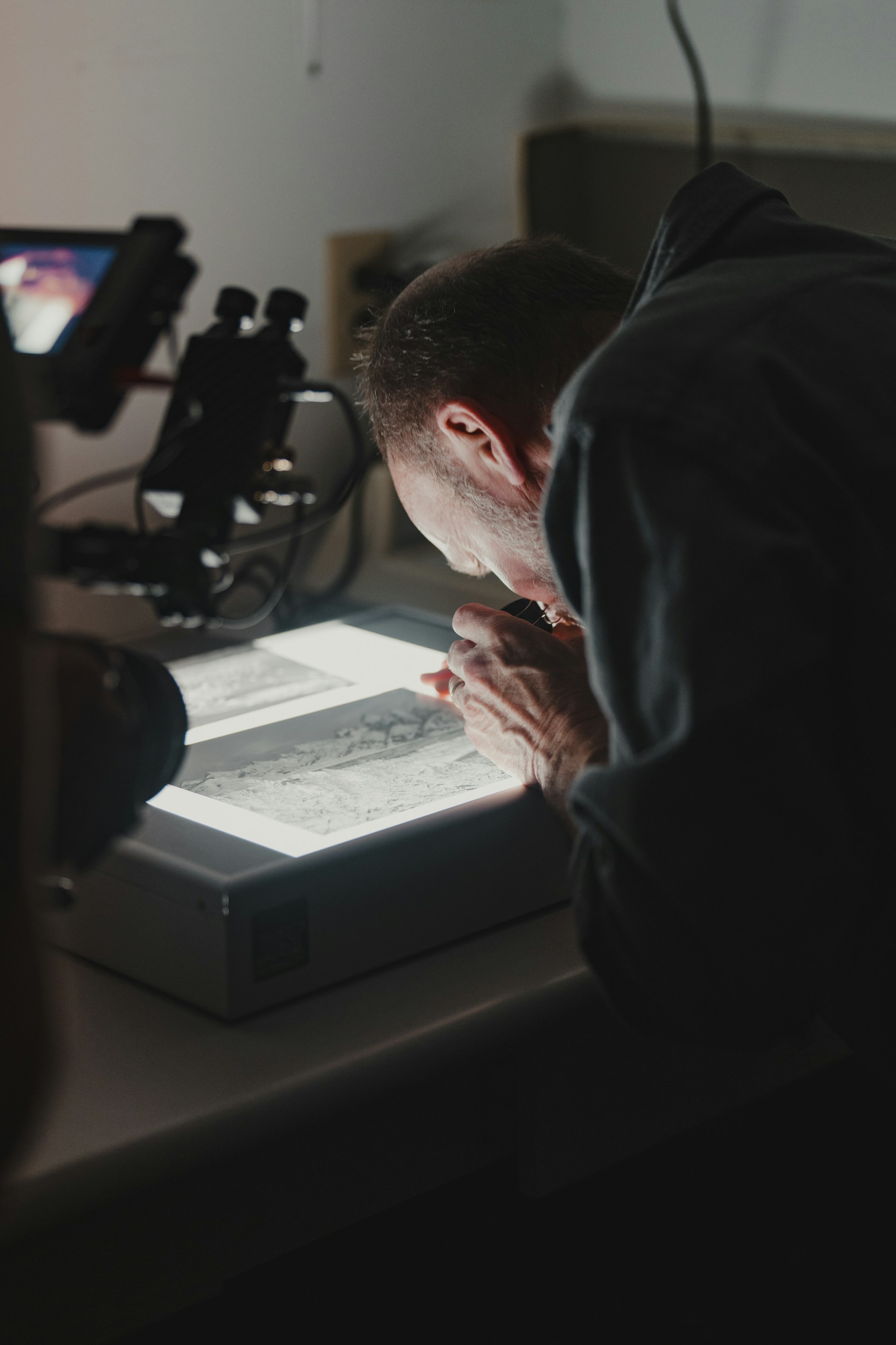 a man sitting at a desk with a tablet