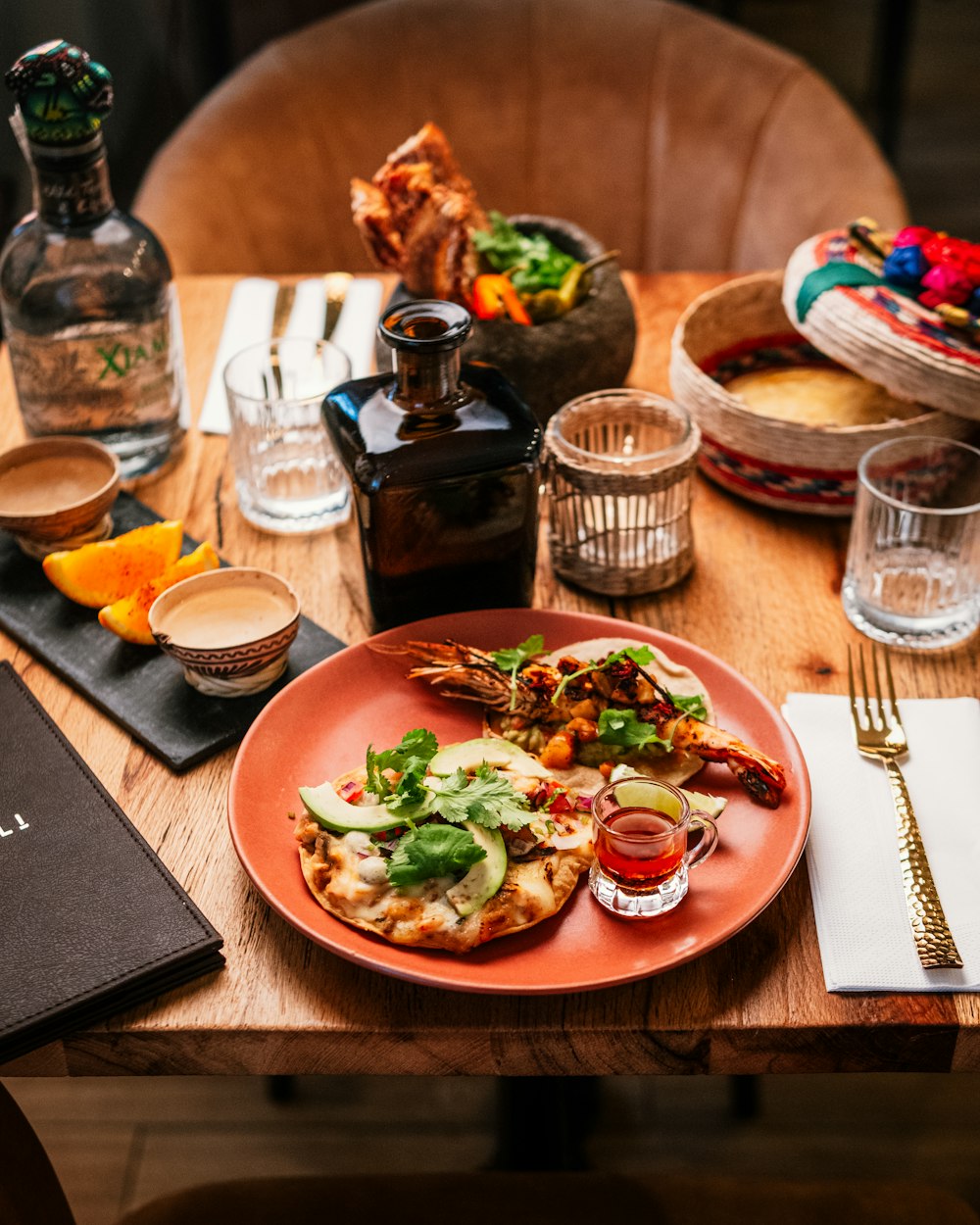 a wooden table topped with a plate of food