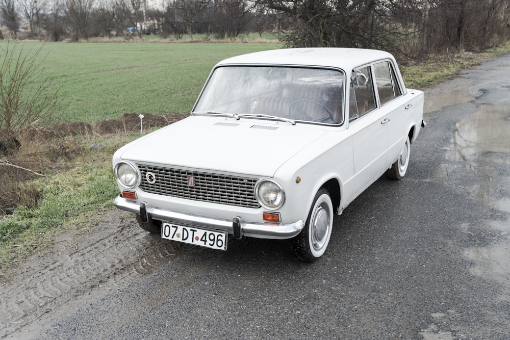 a white car parked on the side of the road