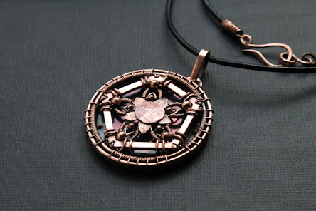 a close up of a necklace on a table