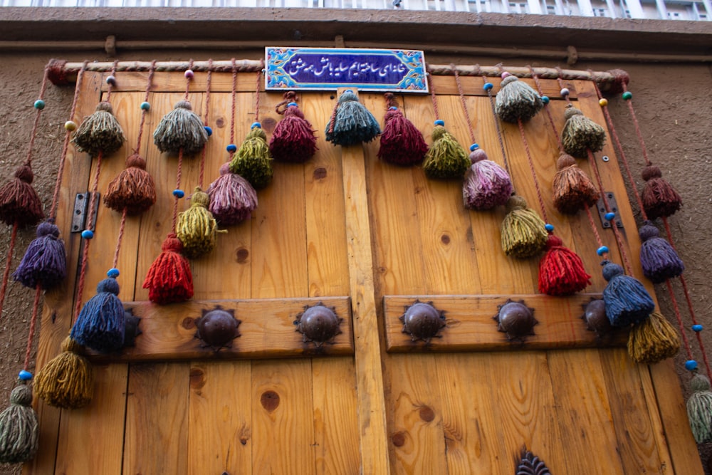 a wooden door with a bunch of tassels on it
