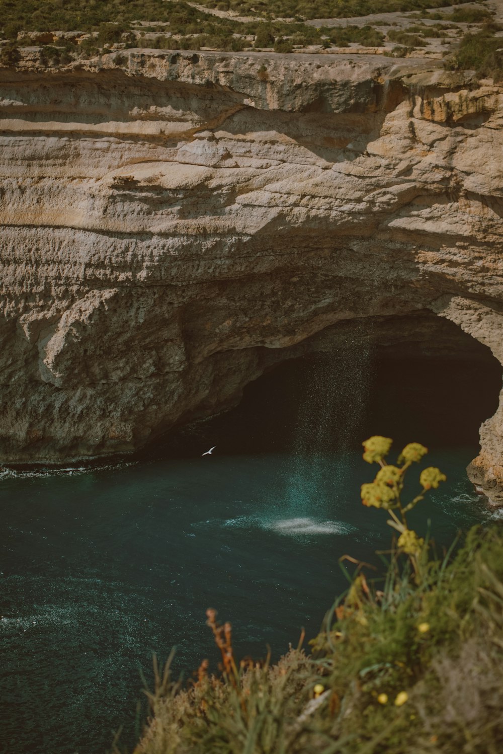 a cave with a body of water in the middle of it