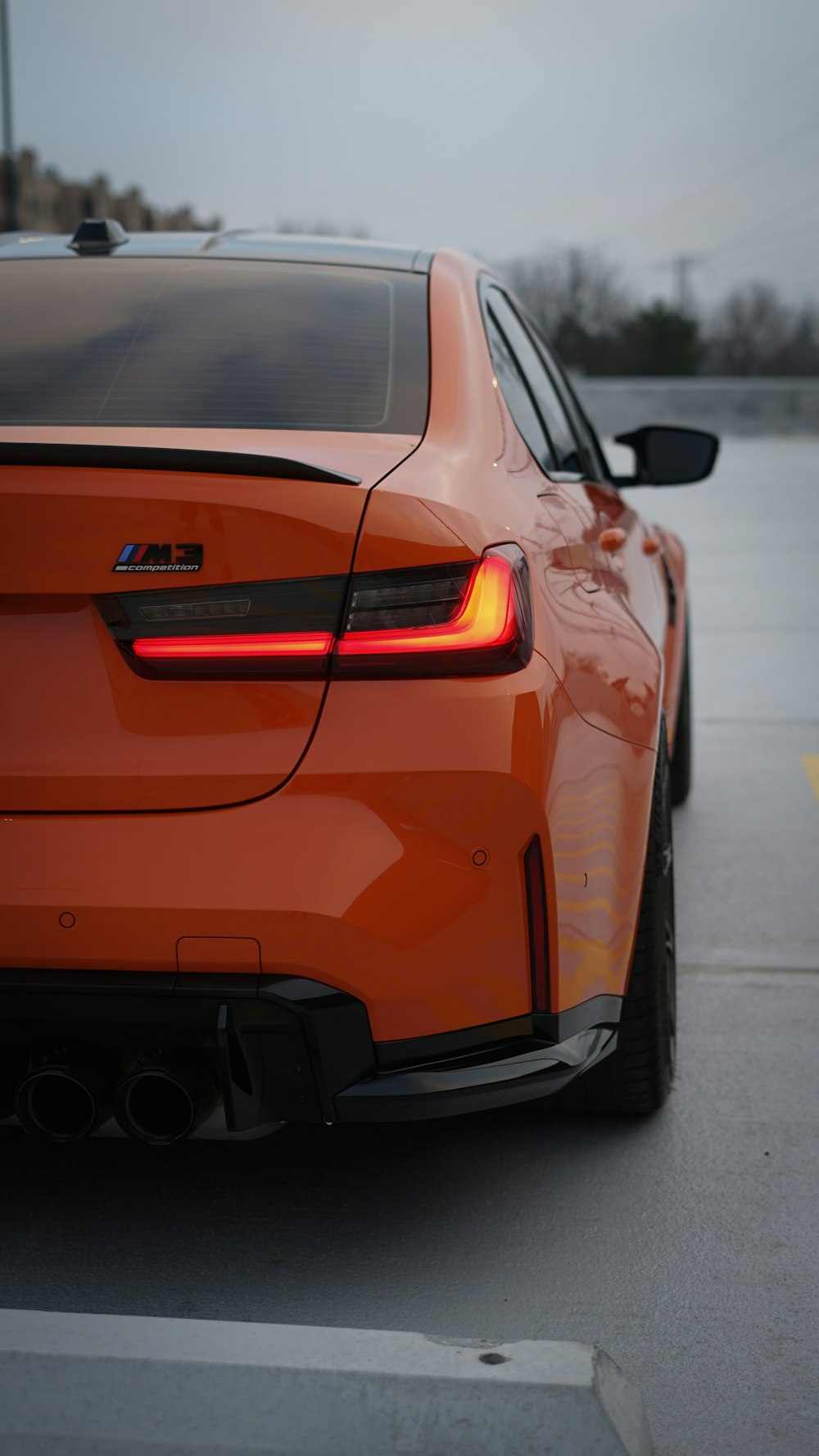 an orange sports car parked in a parking lot