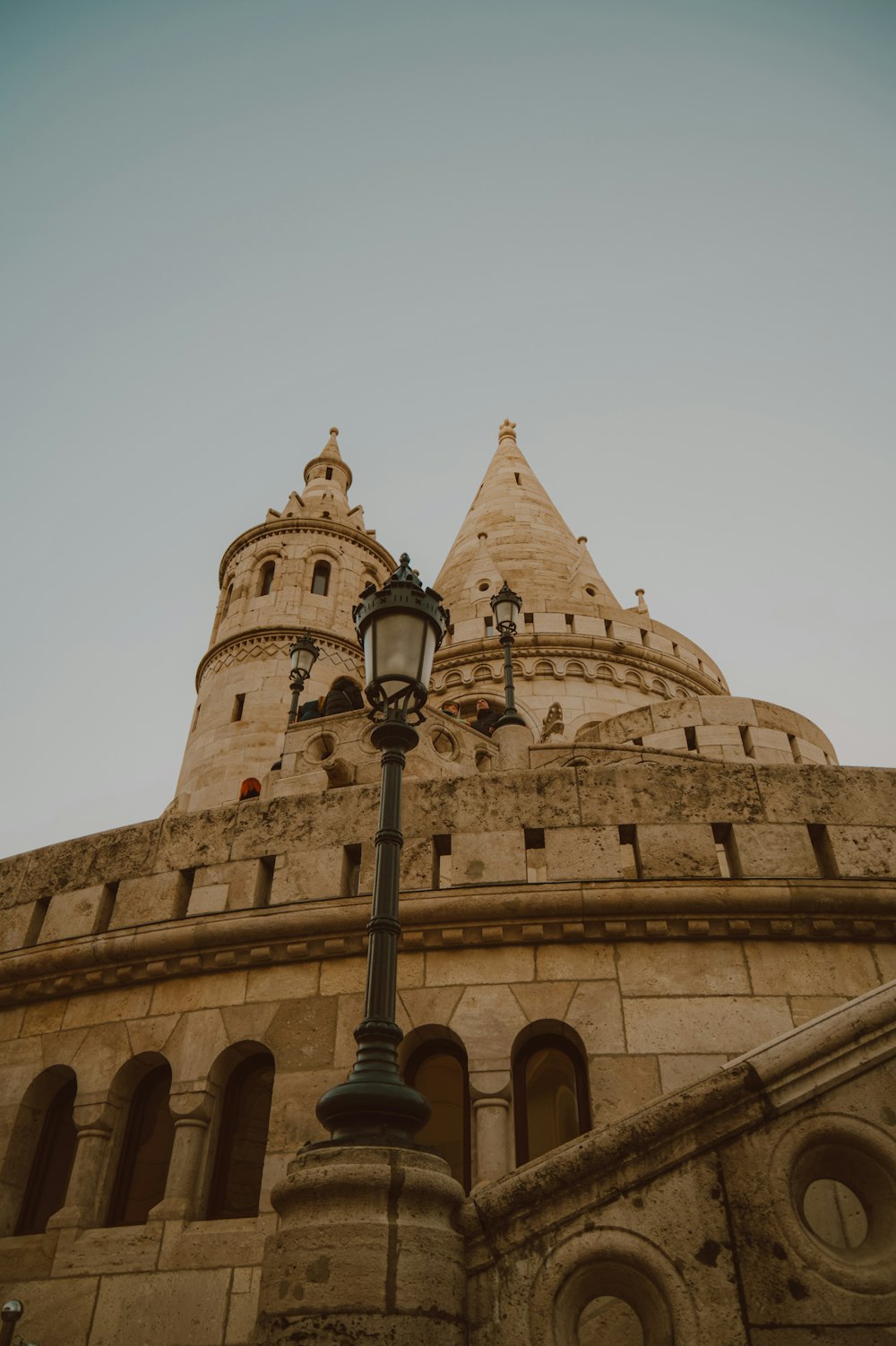 a street light in front of a stone building