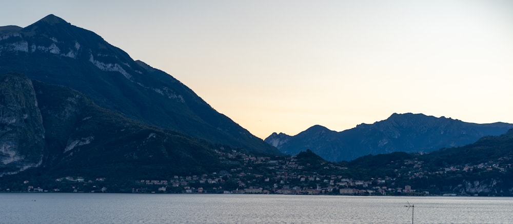 a body of water with mountains in the background