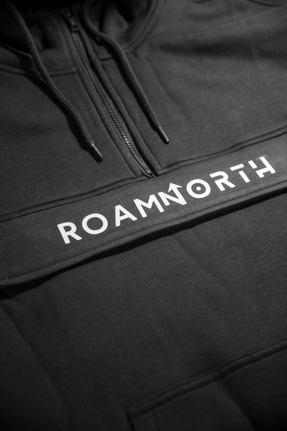 a black sweatshirt with the word roam north printed on it
