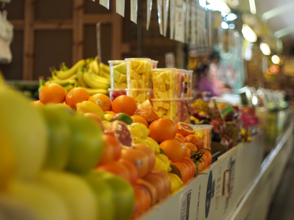 a display in a grocery store filled with lots of fruits and vegetables