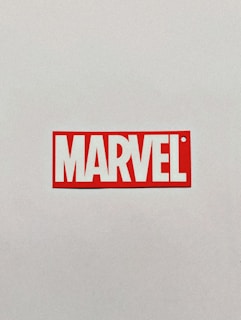 a red and white sticker with the word marvel on it