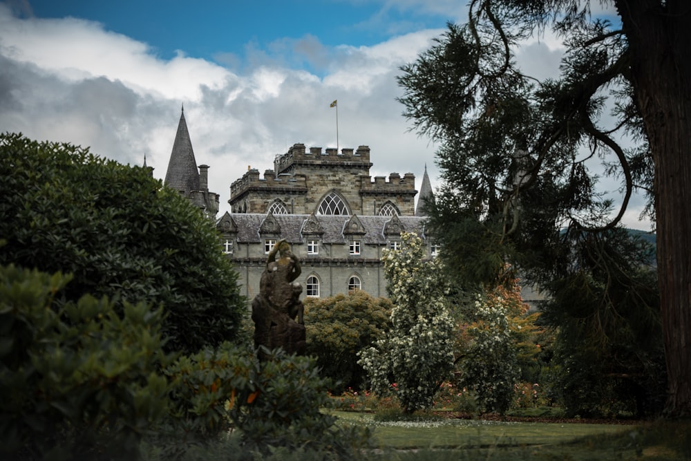 a castle with a statue in front of it