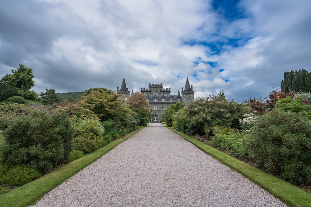 a large castle like building surrounded by lush green trees