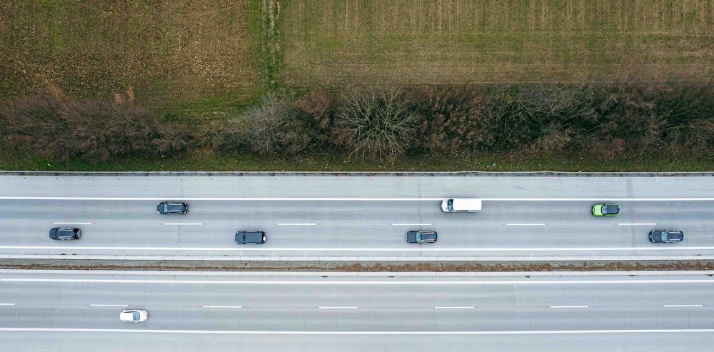an aerial view of a highway with several cars