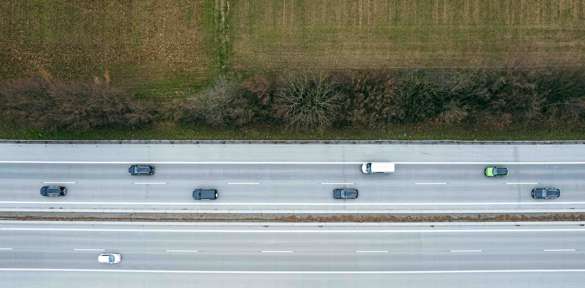 an aerial view of a highway with several cars