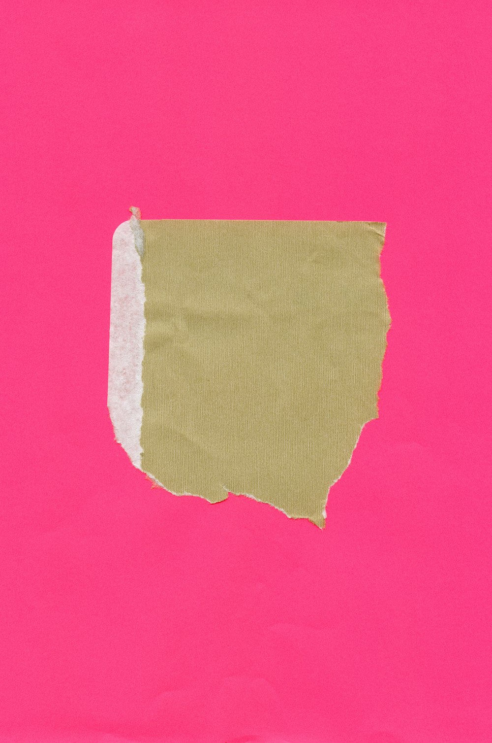 a piece of pink paper with a green strip