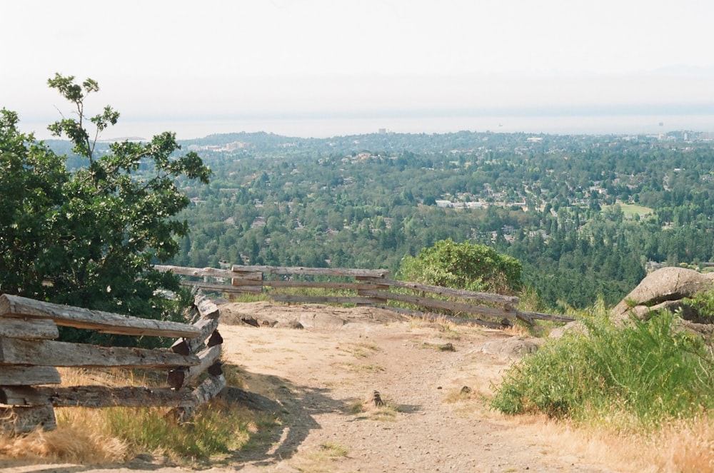 a wooden bench sitting on top of a hill