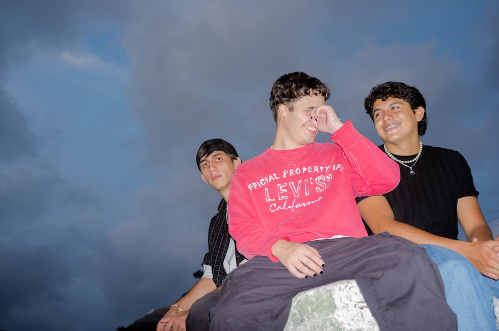 a group of young men sitting next to each other