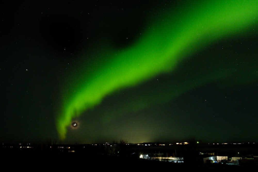 a bright green aurora bore in the night sky