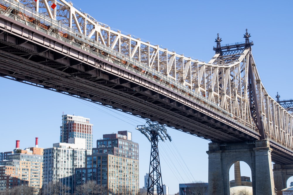 a bridge over a river with a city in the background