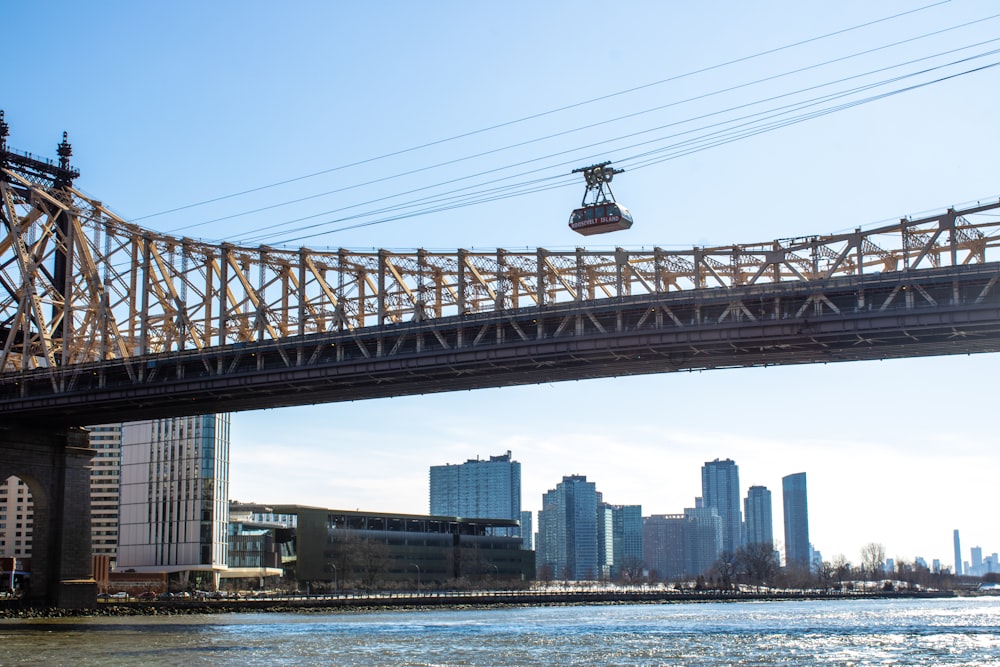 a cable car going over a bridge over a body of water