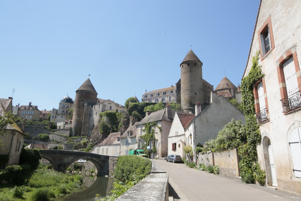 a street with a bridge and a castle in the background