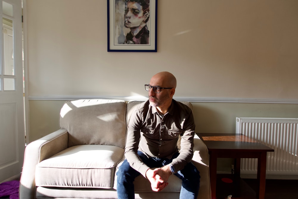 a man sitting on a couch in a living room