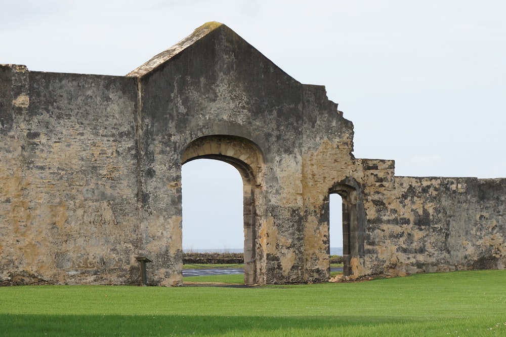 an old stone building with two arched doorways