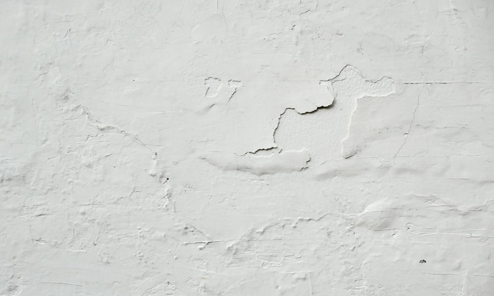 a white wall with a crack in it