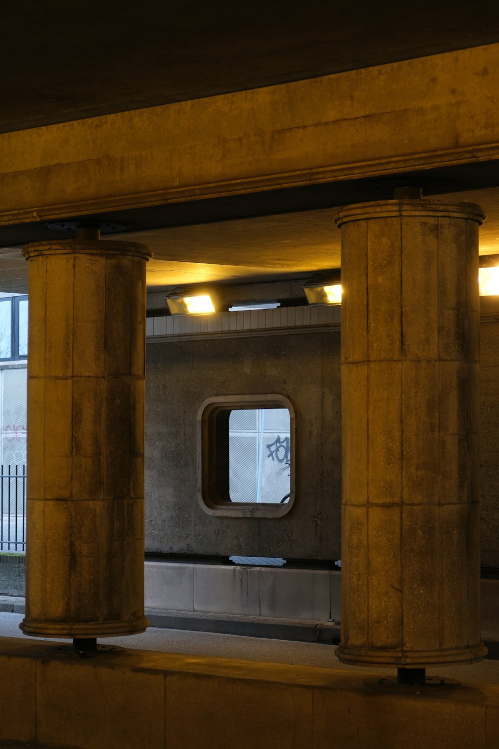 a train station with columns and a window