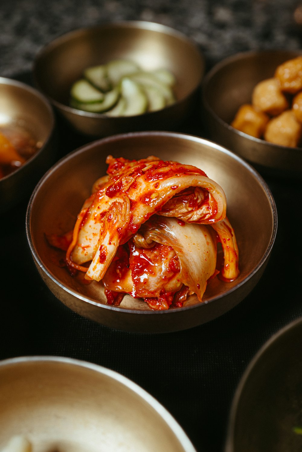 a table topped with bowls filled with food