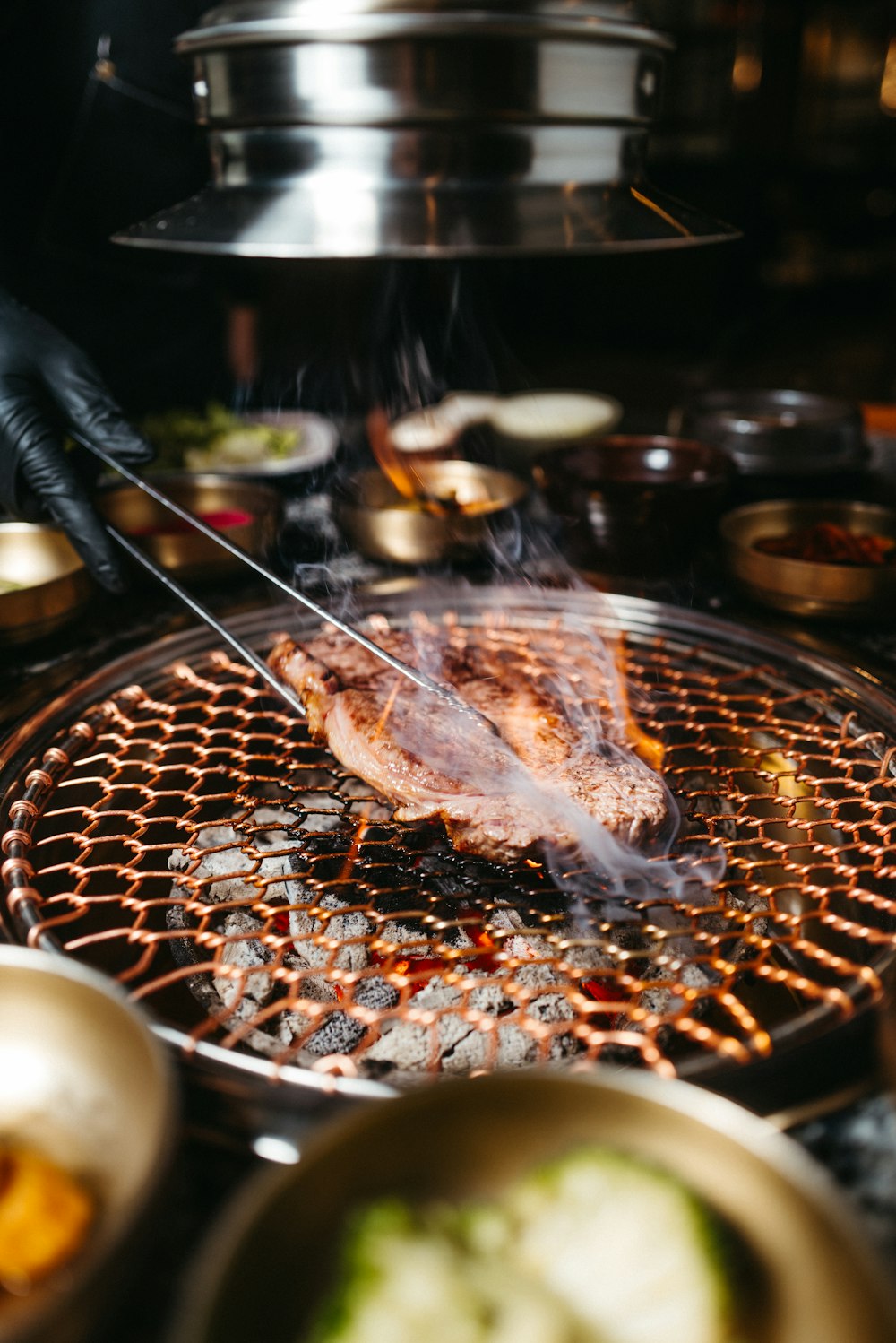 a person cooking food on a grill in a kitchen