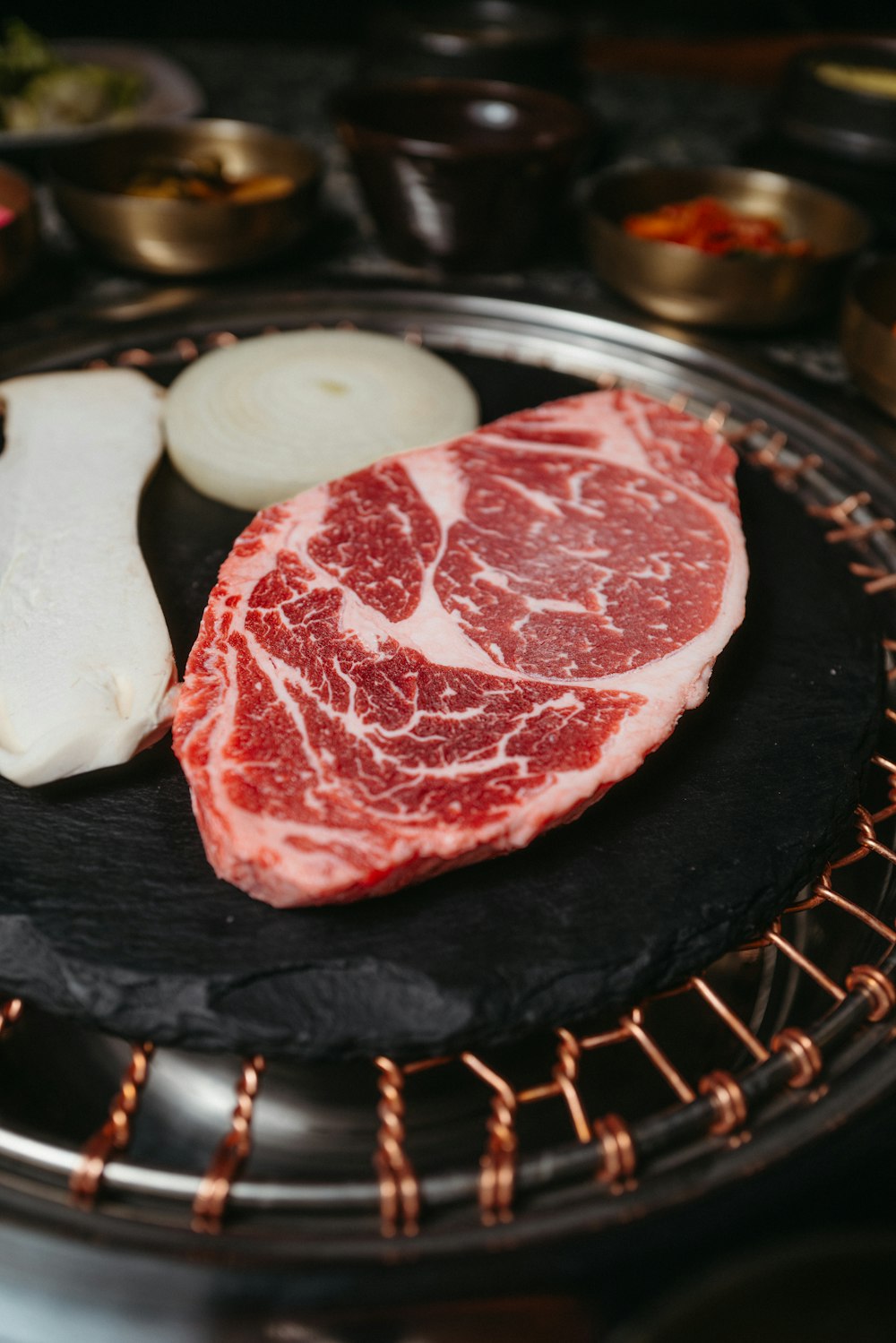 a piece of meat sitting on top of a black plate