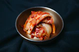 a metal bowl filled with sliced up food