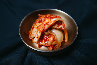 a metal bowl filled with sliced up food