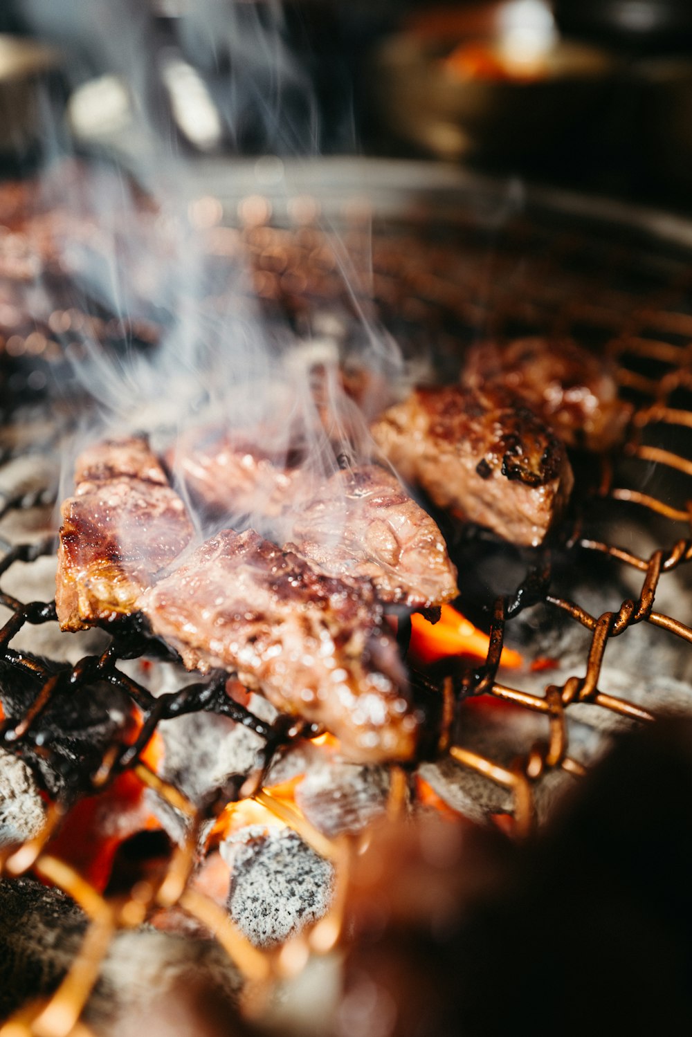 a close up of meat cooking on a grill