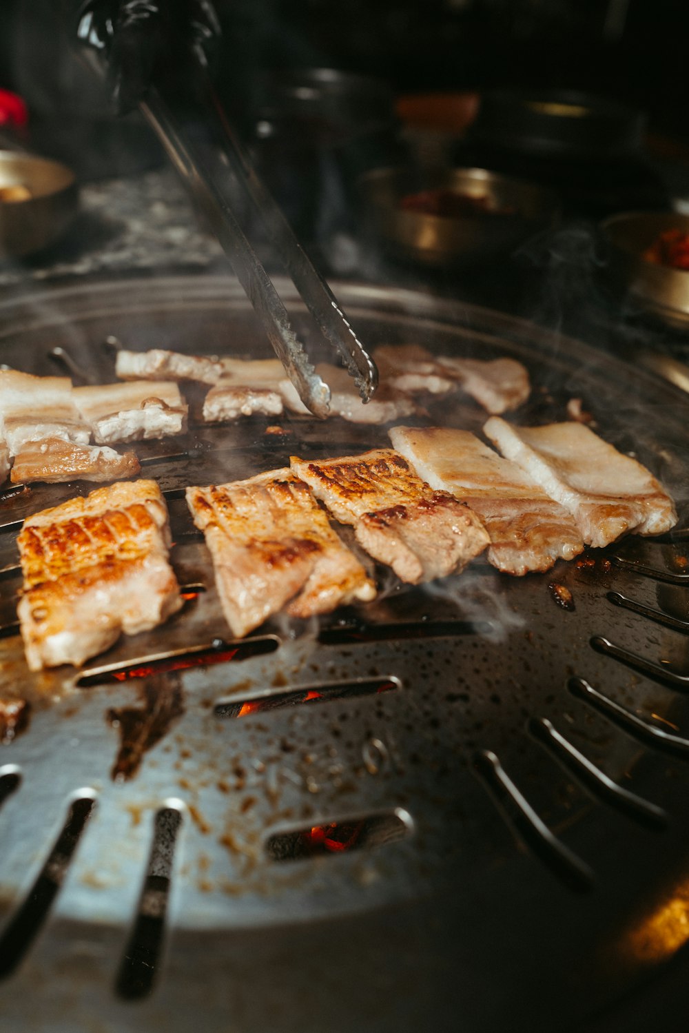 a person is cooking food on a grill