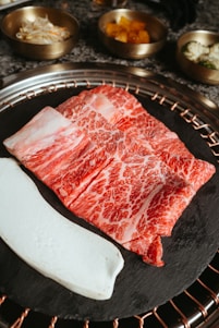 a piece of meat sitting on top of a grill