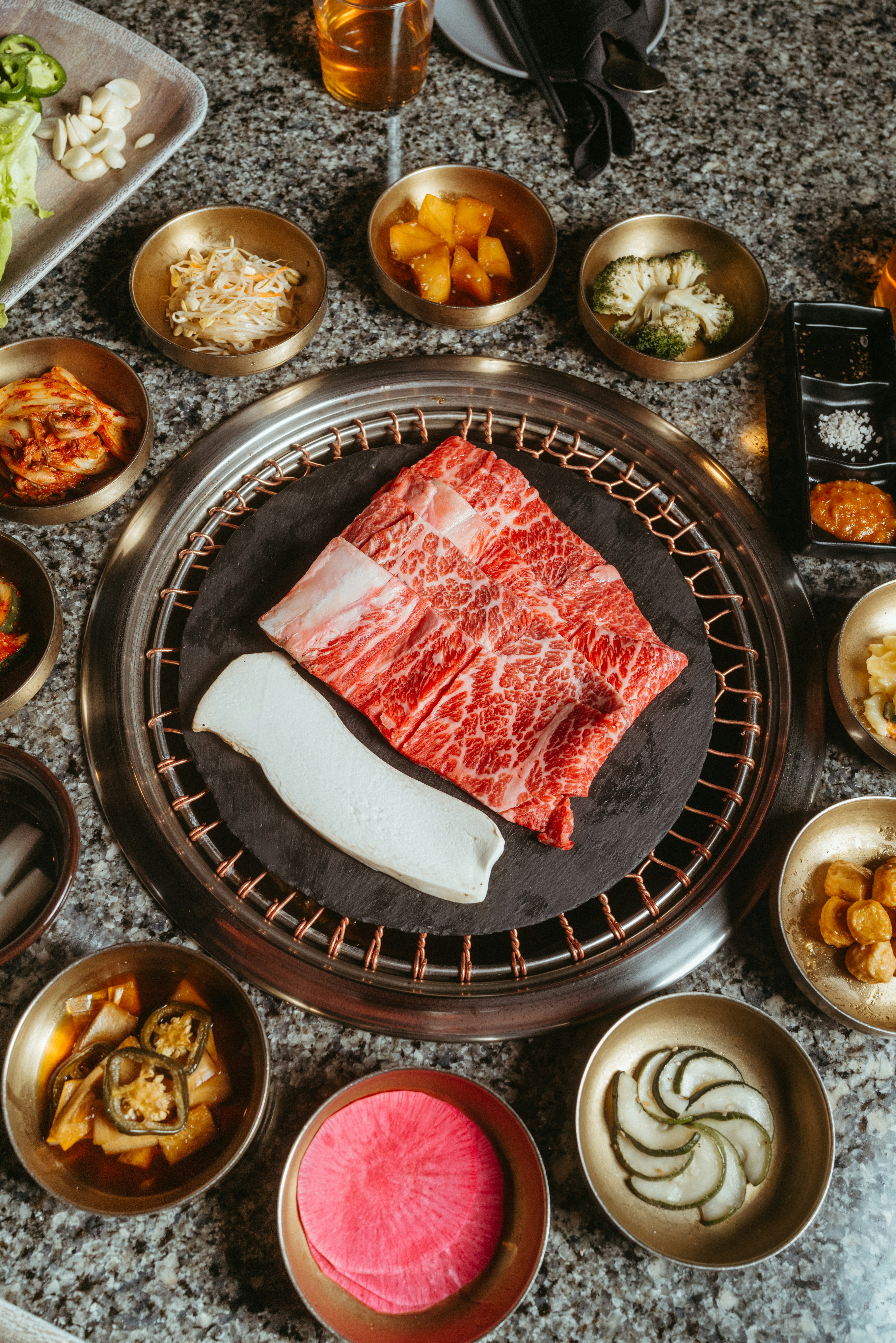 a table topped with bowls of food and meat