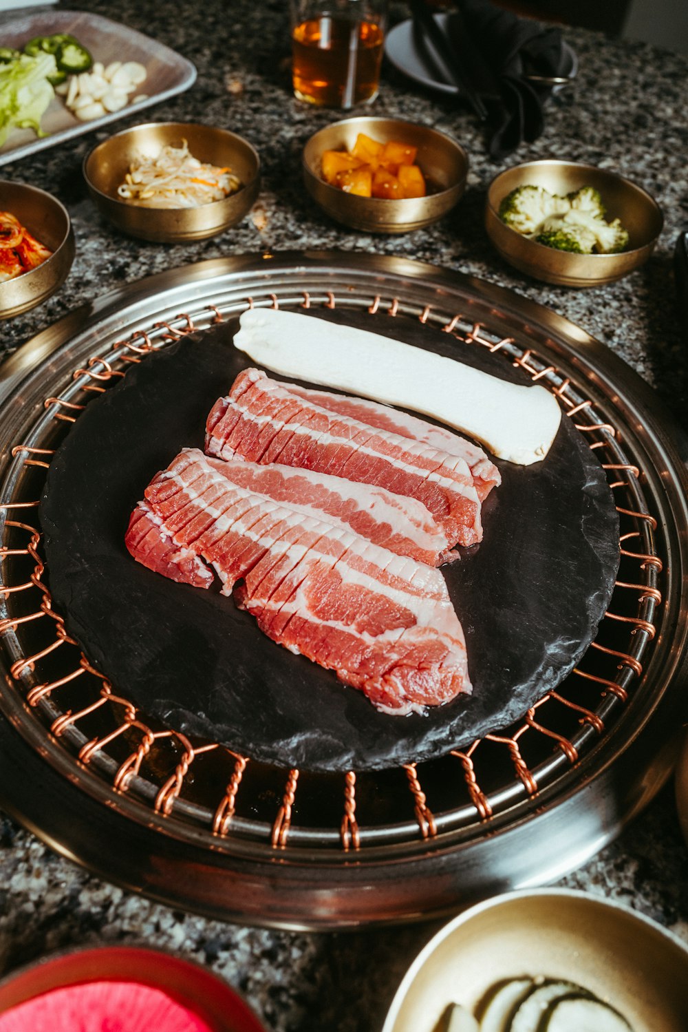 raw meat is cooking on a grill in a kitchen