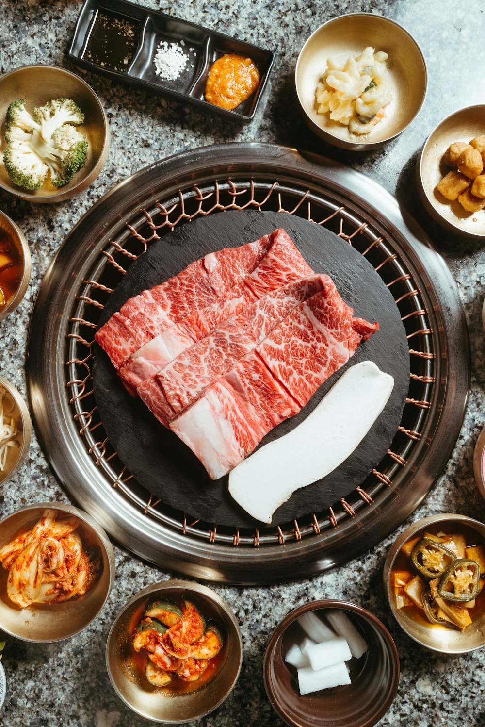 a table topped with bowls of food and meat