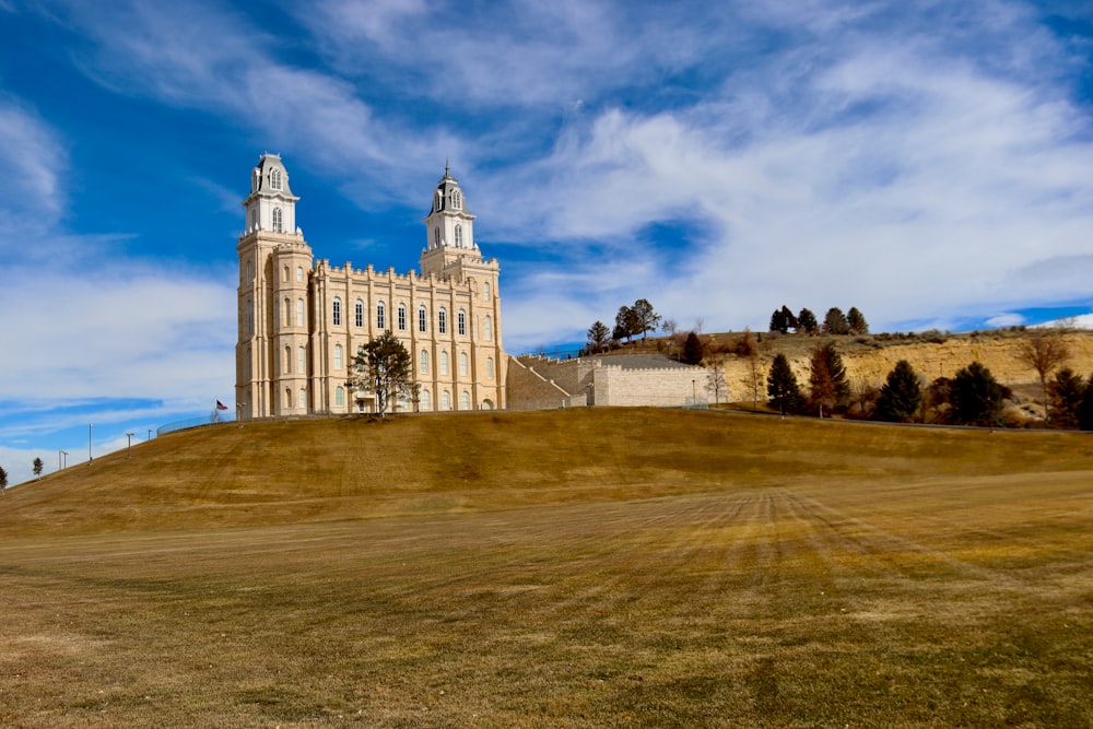 a large building with two towers on top of a hill