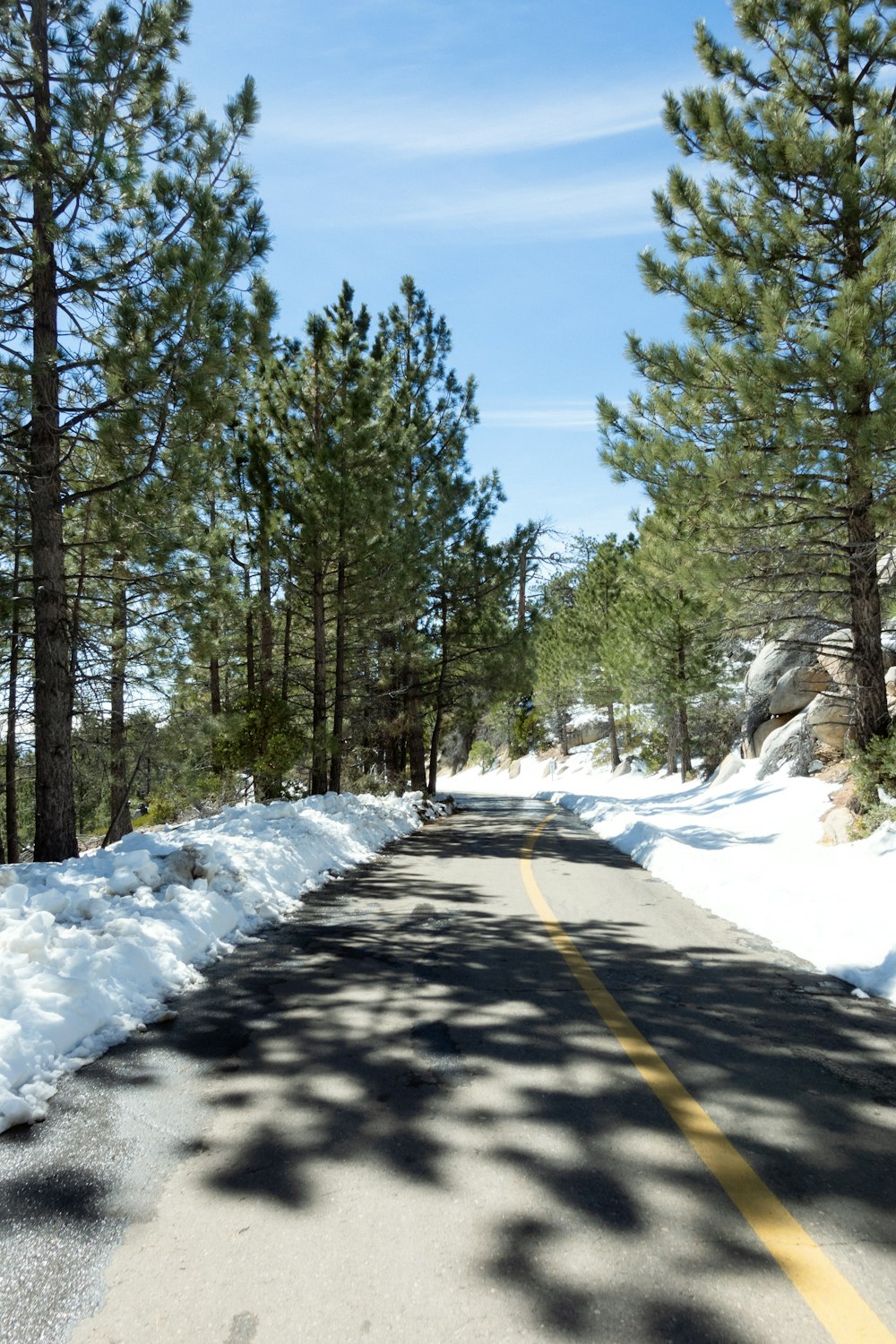 a road that has snow on the side of it