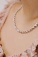 a close up of a person wearing a necklace