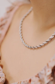 a close up of a person wearing a necklace