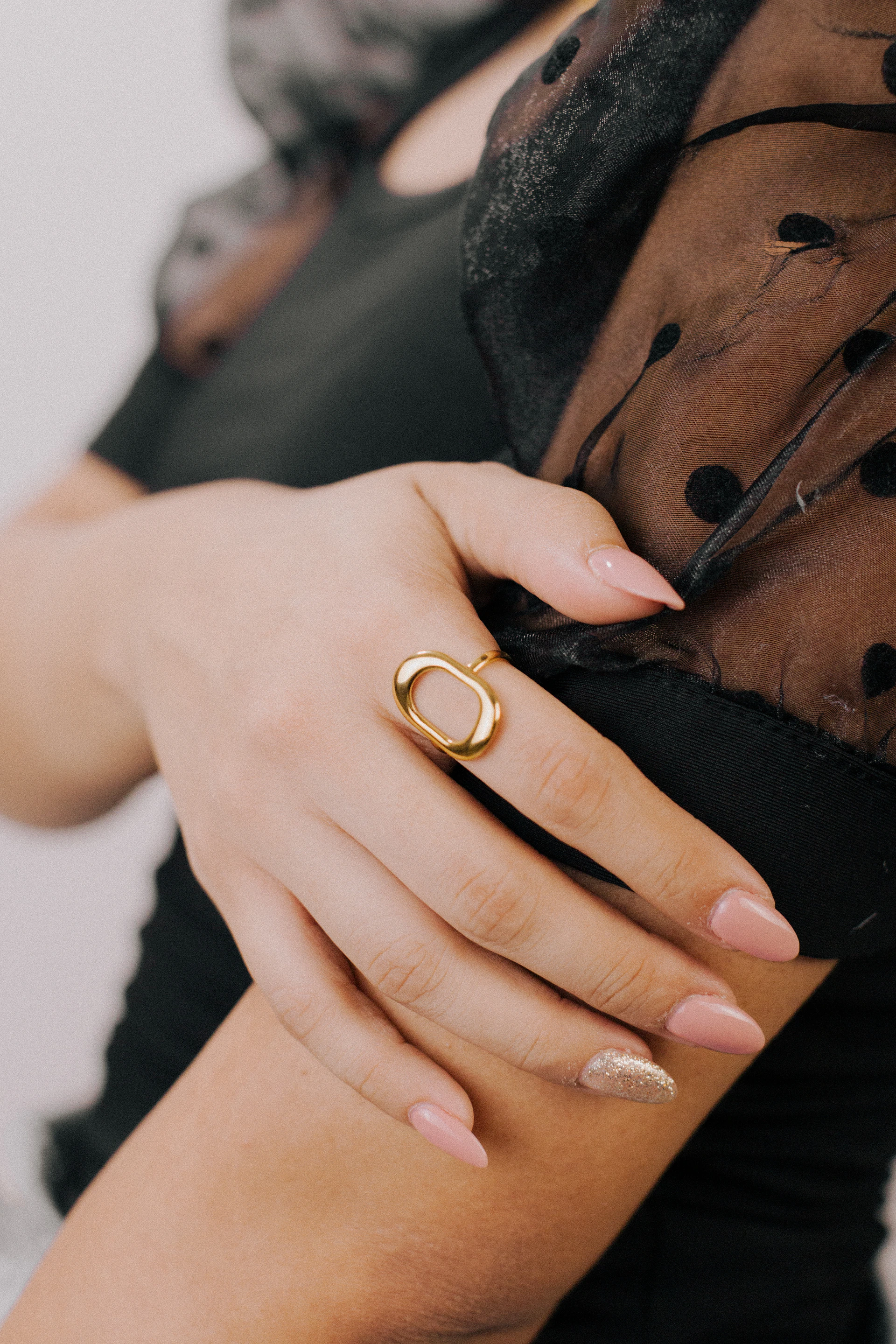 a woman wearing a gold ring on her left hand