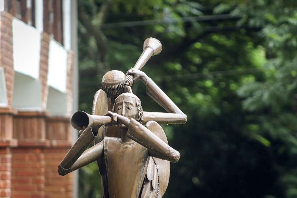a statue of a person holding a baseball bat