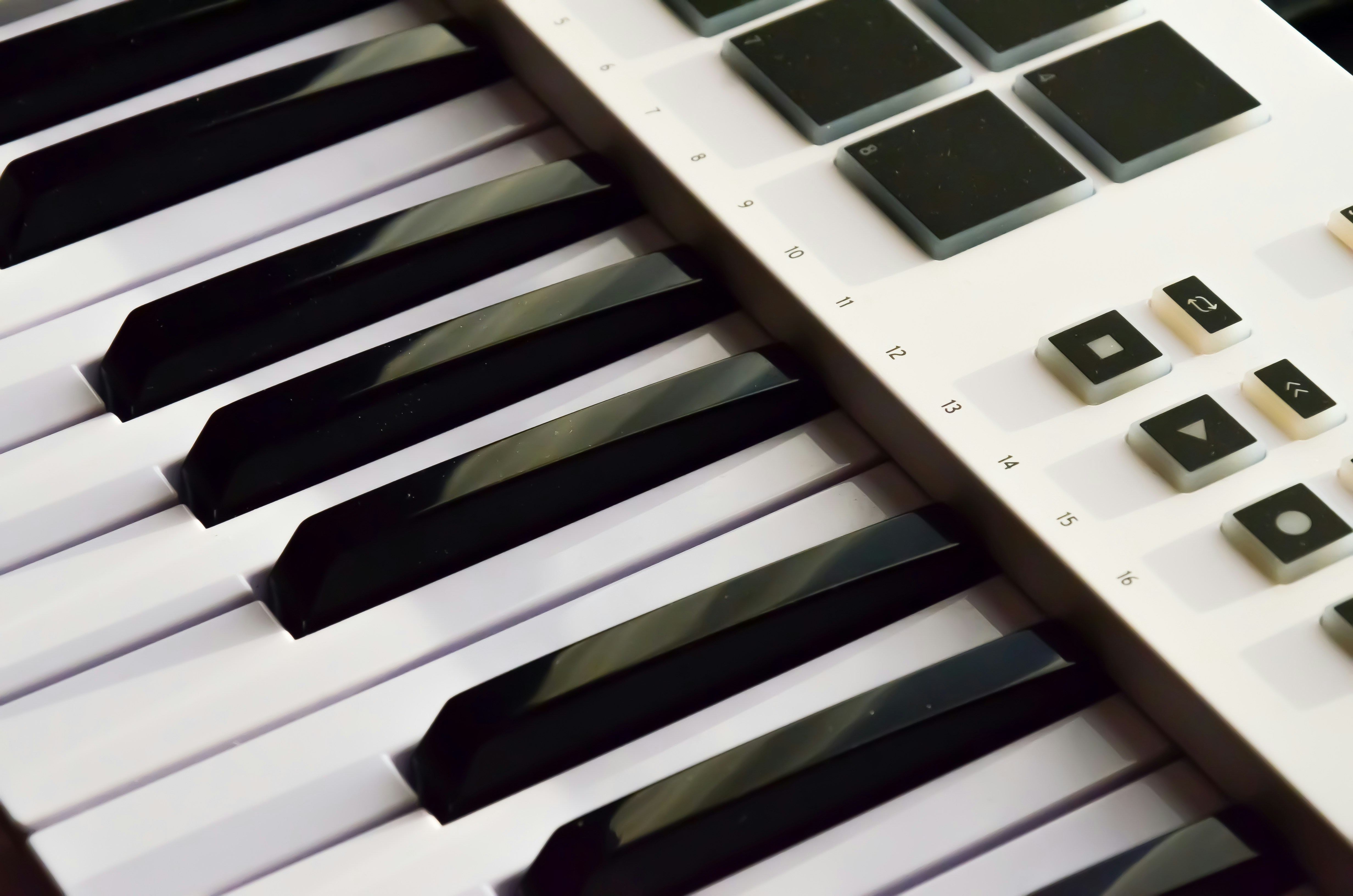 Minimalist MIDI controller keyboard in dark studio