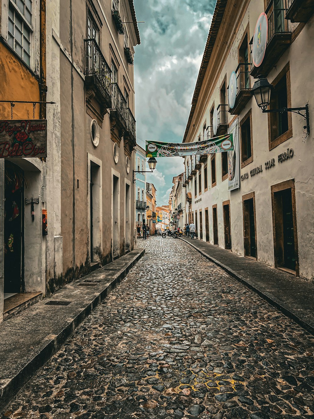 a cobblestone street lined with tall buildings