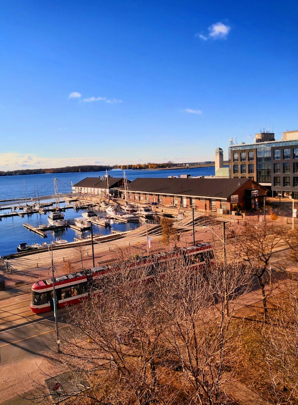 a harbor with boats and a train on the tracks